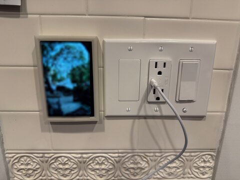 The finished display mounted by the door, showing the live doorbell feed